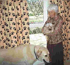 Eileen cuddling a little dog