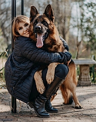 Large dog getting a hug from the breeder
