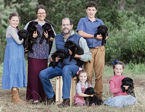 A family rearing black Labradors.